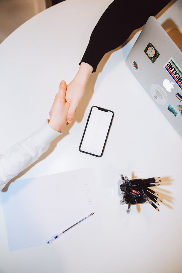 Two people shaking hands in a modern office